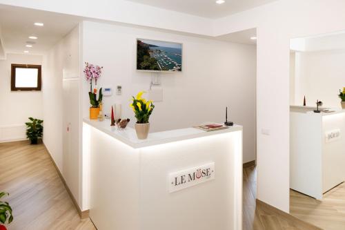 a white counter in a room with flowers at Le Muse Suite in Sorrento