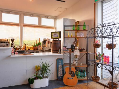 a store with a guitar on display in a room at Sound Swell Resort in Minamiboso