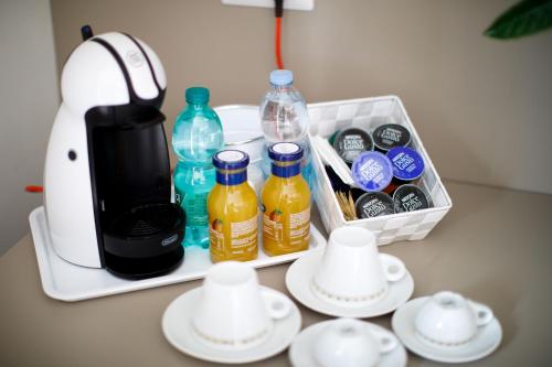 a tea kettle and bottles and cups on a table at Le Muse Suite in Sorrento