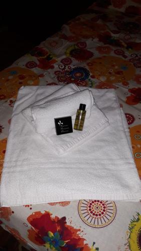 a white shirt with a candle on top of a bed at CA' VIRASOLELH in Macra