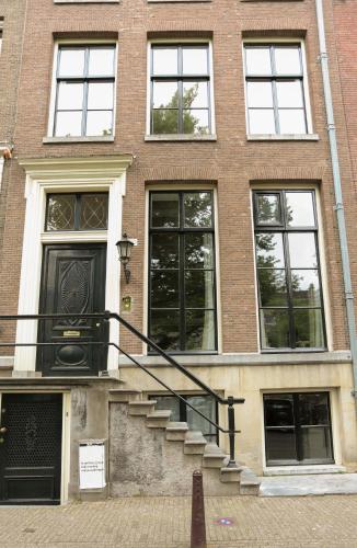 a brick building with stairs in front of it at EMPIRIC Keizersgracht in Amsterdam