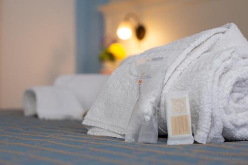 a towel and a bottle of soap sitting on a bed at Camping Village La Pineta in San Vito lo Capo