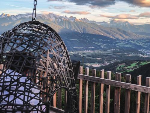 a gazebo with a view of a mountain at Tratterhof Mountain Sky Hotel in Maranza