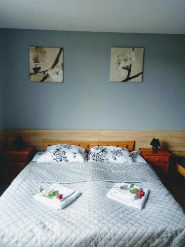 a bedroom with a bed with two towels on it at Noclegi na Heweliusza in Sanok