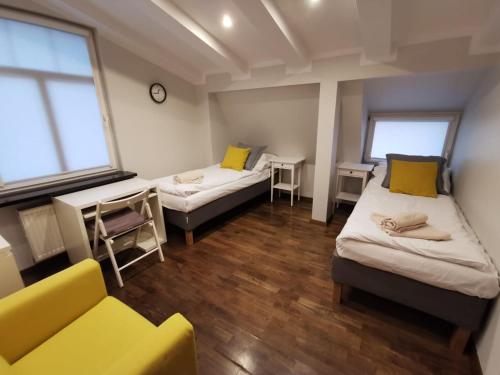 a room with two beds and a couch in it at Sopot Przy Plaży in Sopot