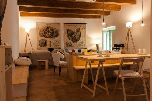 a living room with a table and some chairs at BORGO PETELIA, Casa Castiglione, Antica casa su due piani con scala esterna in Strongoli