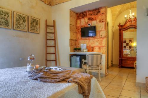 a bedroom with a bed and a table with candles at Masseria Sorani in Manduria