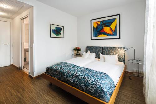 ein Schlafzimmer mit einem Bett in einem Zimmer in der Unterkunft Business & Art Hotel Markgraf in Emmendingen