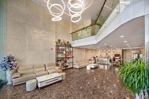a large lobby with couches and a pharmacy at Lavender Riverside Hotel in Da Nang