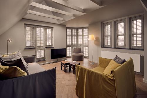 a living room with two couches and a tv at Hotel Miss Blanche in Groningen
