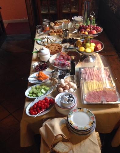 a long table with many plates of food on it at Agriturismo Settepassi Tuscany in Ponte Buggianese