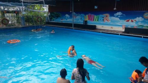 a group of people in a swimming pool at Motel Bao Linh in Vung Tau