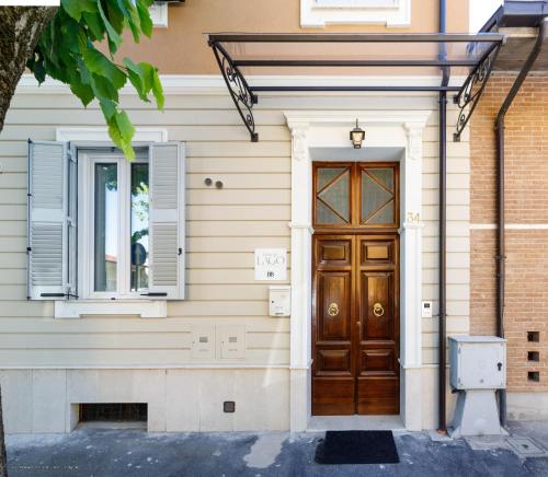 a house with a wooden door and a window at C'era Un Lago in Avezzano