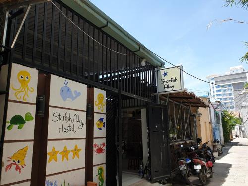 a building with signs on the side of it at Starfish Alley Hostel in Da Nang