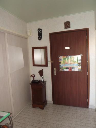 a room with a door and a table and a mirror at L'Arinella in Bastia