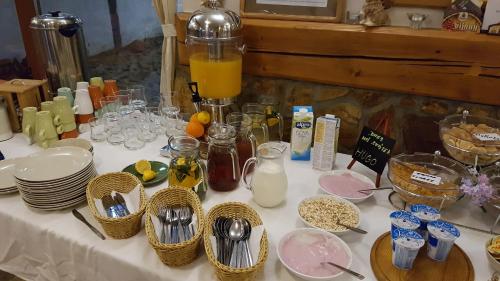 a table topped with plates and bowls of food at Hotel Farma Vysoká in Chrastava