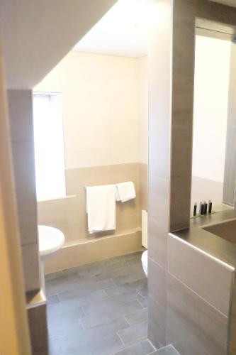 a bathroom with a toilet and a sink at Weston Hall Hotel Sure Hotel Collection by Best Western in Bulkington