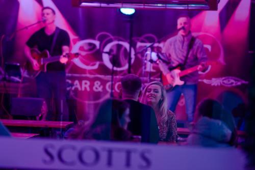 a group of people playing instruments in a room at Scott's Hotel in Killarney