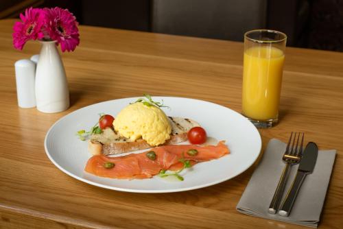 a plate of food on a table with a glass of orange juice at Scott's Hotel in Killarney