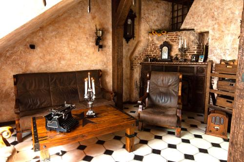 a room with a couch and a table and a chair at Attic Apartment Warszawa in Warsaw