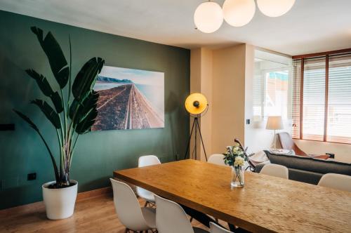 a dining room with a table and a potted plant at Level 11 Apartment in Aguadulce