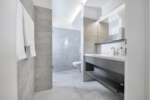 a bathroom with a sink and a toilet at Hotel Gösser Bräu in Wels