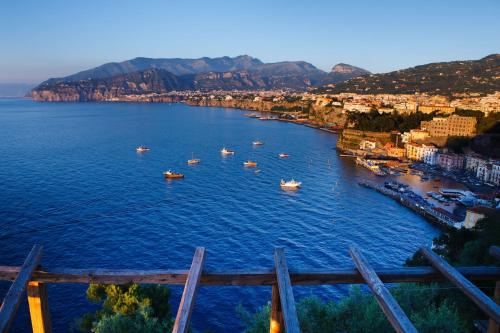 a group of boats in a large body of water at Le Muse Suite in Sorrento