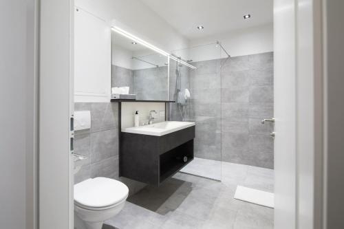 a bathroom with a toilet and a sink and a shower at Hotel Gösser Bräu in Wels
