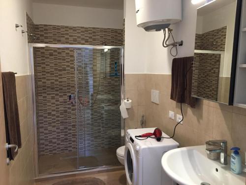 a bathroom with a shower and a toilet and a sink at CAV Mameli in Dorgali