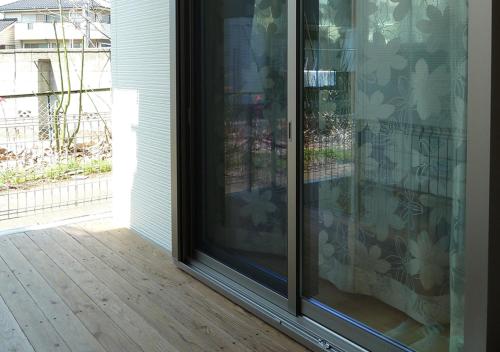 a sliding glass door on a porch with a patio at Kanaloa Funabashi in Funabashi