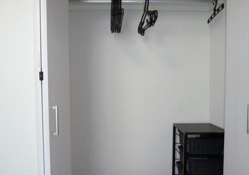 a door to a room with a white wall at Kanaloa Funabashi in Funabashi