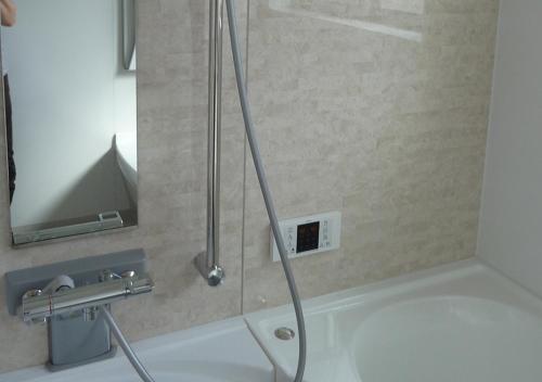 a shower with a glass door in a bathroom at Kanaloa Funabashi in Funabashi