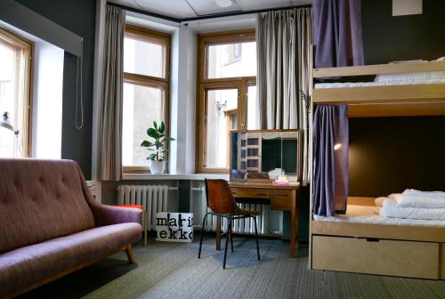 a bedroom with a desk and a bunk bed at The Yard Hostel in Helsinki