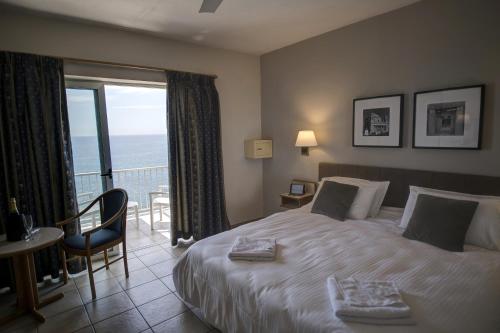 A bed or beds in a room at Sliema Chalet Hotel