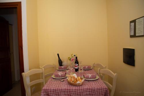 a table with a table cloth and a bowl of fruit on it at Camping Village La Pineta in San Vito lo Capo