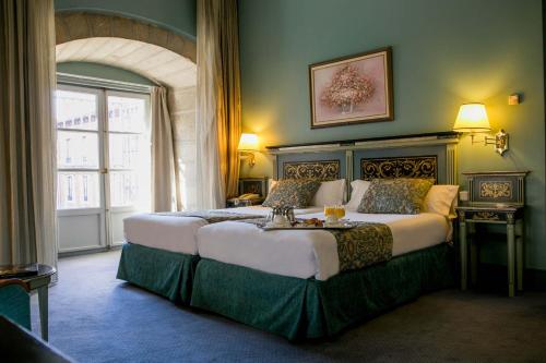 מיטה או מיטות בחדר ב-Palacio de los Velada