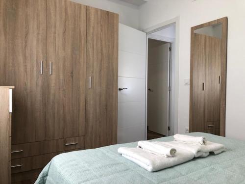Ένα ή περισσότερα κρεβάτια σε δωμάτιο στο RG apartamentos