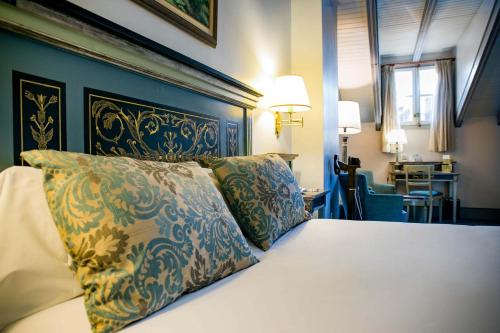 a bedroom with a bed with two pillows on it at Palacio de los Velada in Avila