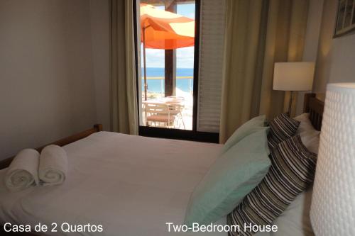 a bedroom with a bed with a view of the ocean at First Balcony - Porto Santo in Porto Santo