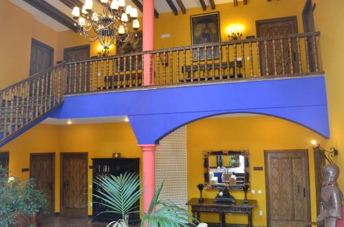 a blue staircase in a room with yellow walls at Complejo turístico Quinta La Espadaña in Bedriñana