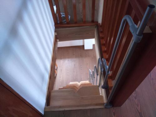 an overhead view of a wooden staircase with a stair railing at Jurahaus Maisonette Wohnung in Solnhofen