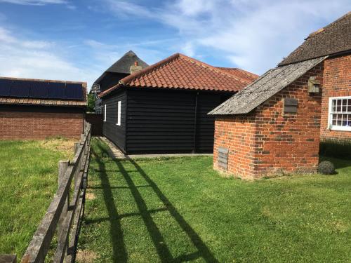 a view of a house and a brick building at The Stables Kings Ripton in Huntingdon
