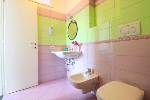 a bathroom with a toilet and a sink at Casa Vacanze Il Postino in SantʼAgata sui Due Golfi
