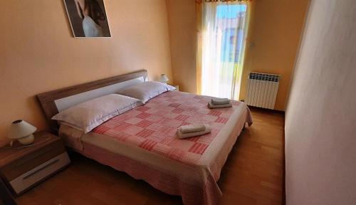 a bedroom with a bed with two towels on it at PARADISE Beach Apartments in Rovinj