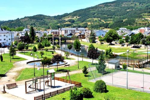 a park in a city with a mountain in the background at Casa los Ancares in Vega de Espinareda