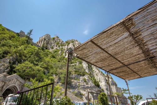 a building with a mountain in the background at Hôtel de la Citadelle in Sisteron