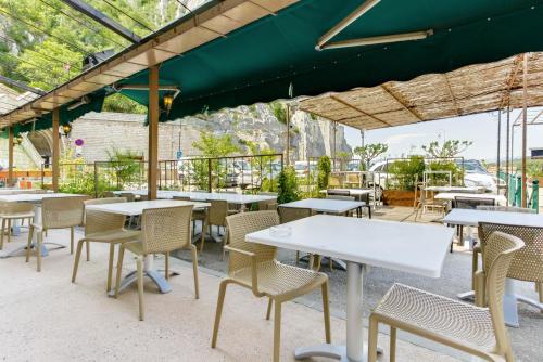 a row of tables and chairs in a restaurant at Hôtel de la Citadelle in Sisteron