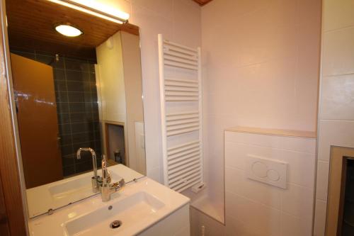 a bathroom with a sink and a mirror at Appt 4/5 pers. Les Saisies front de neige in Les Saisies