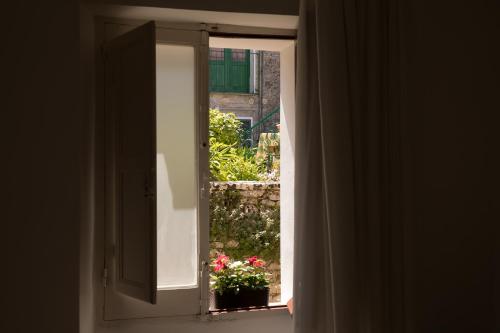 an open door with a window with a potted plant at Bella Vista b&b in Erice