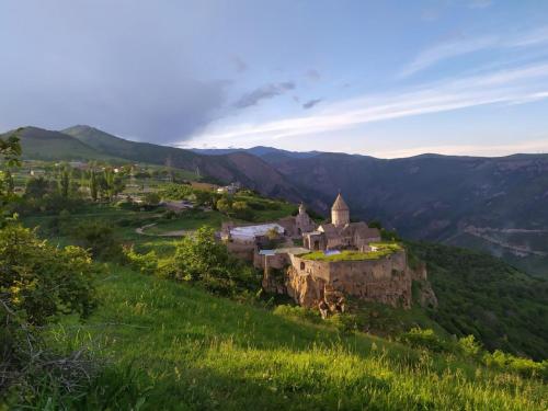 an old castle on a hill in a green field at Ana-Maria Bnb in Tatʼev